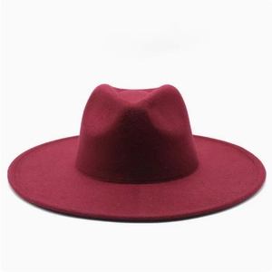 Close-up of a burgundy wool fedora hat with a flat brim and reinforced stitching detail