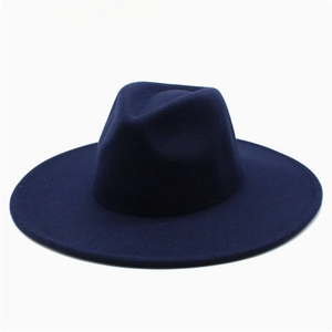 Detailed view of a navy blue wide brim wool fedora hat with classic indented crown design
