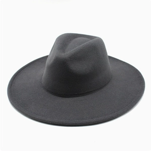 Top view of a classic black wide-brimmed wool fedora hat with a grooved crown design
