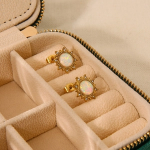 Close-up of vintage sunflower stud earrings with iridescent opal and zircon stones