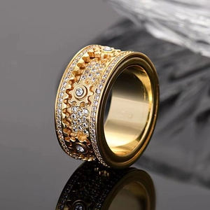 Macro detail of gold steampunk gear ring with white zircon micro-inlay accents