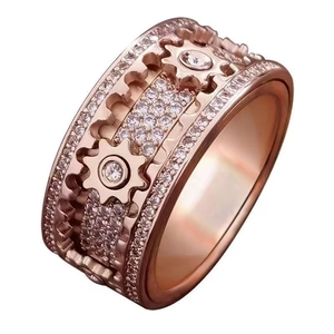 Macro view of rose gold mechanical gear ring with sparkling white zircon crystals