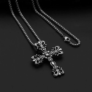 Detail view of retro gothic cross pendant with intricate baroque carvings and box chain