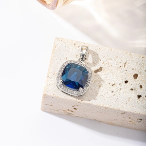 Elegant silver square blue sapphire halo pendant necklace for women on a stone base