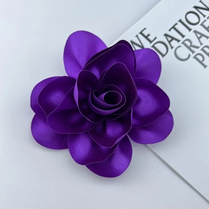 Detailed macro view of a 14cm purple satin flower brooch with handmade layered petals
