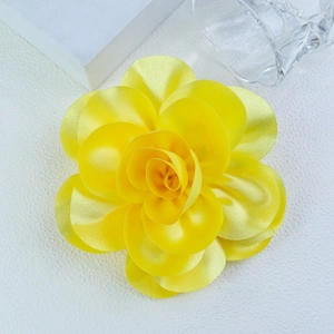Macro shot of 14cm yellow satin floral brooch showing textured petals and fabric detail
