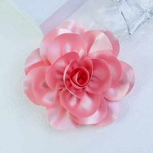 Detailed macro view of 14cm pink satin fabric flower brooch with elegant silk texture
