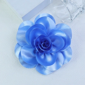 Macro shot of 14cm sky blue satin handmade flower showing layered petals and texture