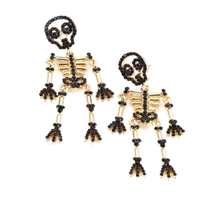 Gothic gold skeleton earrings with black rhinestones and pearls on white background