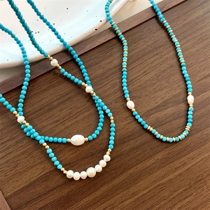 Natural turquoise and freshwater pearl beaded necklace with gold accents in elegant style