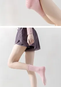 Close-up of pink yoga socks with non-slip silicone grips and elastic ribbed cuffs