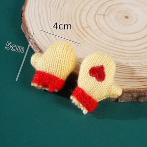 Macro shot of mini knitted gloves with red heart detail and 5cm size dimensions