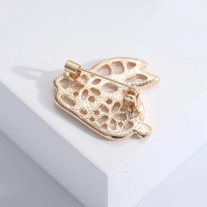Back view of rabbit brooch in gold hollow metal with secure safety pin fastener