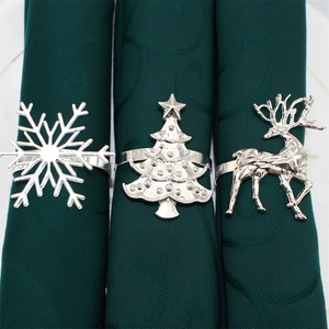 Christmas napkin rings set featuring silver reindeer, snowflake and tree for table decor