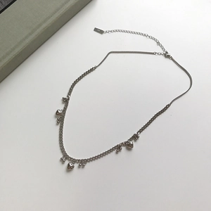 Detail of S925 sterling silver beaded necklace with polished heart pendants and clasp