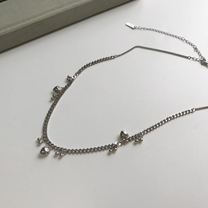 Detail of S925 sterling silver beaded necklace with heart-shaped pendants and small beads