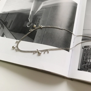 Macro detail of S925 sterling silver beaded necklace with dangling heart charms