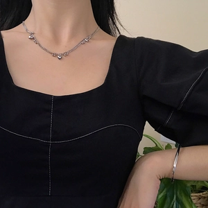 Detail of S925 silver beaded chain necklace with heart charms and polished bangle