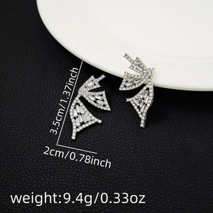 Macro shot of silver butterfly tassel earrings with cubic zirconia and dimension labels