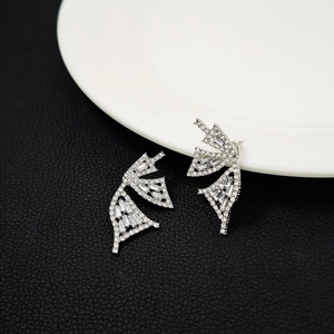 Macro shot of silver butterfly wing earrings with shimmering cubic zirconia inlay