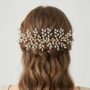 Macro shot of silver bridal hair comb with rhinestones and white pearls on gold wire