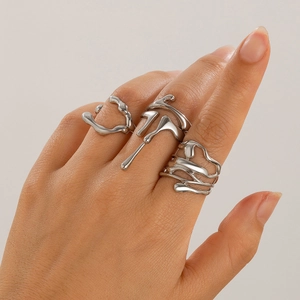 Detailed view of silver liquid metal rings with irregular lava design on hand