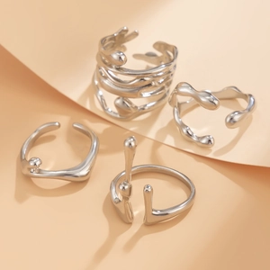 Macro view of silver lava-inspired open rings with liquid metal aesthetic and mirror finish