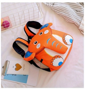 Detailed view of 3D elephant backpack for toddlers with orange fabric and cute blue ears
