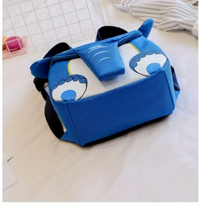 Detail shot of blue elephant kids backpack with 3D ears and adjustable straps on white bed