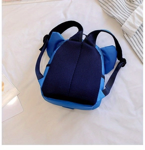Detail of children's blue backpack featuring breathable mesh padding and adjustable straps