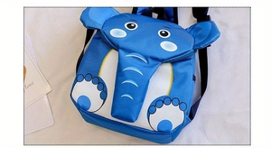 Detail view of a blue elephant cartoon backpack for kids with 3D ears and adjustable straps