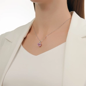Close-up of S925 silver necklace with heart-shaped pink zircon pendant worn on neck