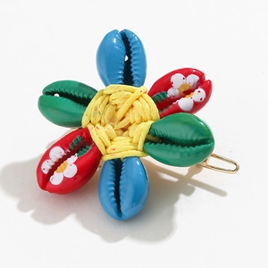 Bohemian floral hair clip with painted shell petals and yellow woven center