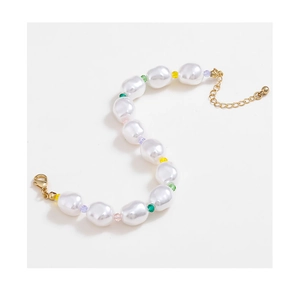 Dettaglio di bracciale con perle barocche, perline di vetro colorate e chiusura dorata