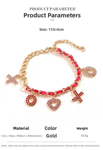 Detail view of heart and XO pendants on a gold chain with pink ribbon and rhinestones