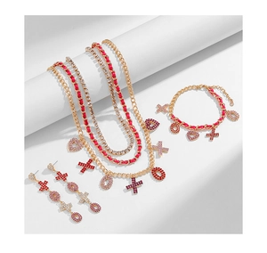 Detail view of XOXO heart jewelry set with red ribbon and layered crystal necklace