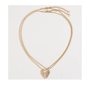 Detailed macro view of the double-layered broken heart puzzle pendants on golden ball chains