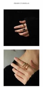 Detail of vintage gold stackable rings featuring black gemstone and textured bands