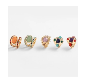 Detailed row of vintage style gold rings with turquoise and tiger eye stone accents