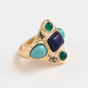 Vintage gold cocktail ring featuring blue stone inlay and colorful gemstone accents