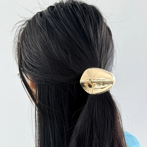 Élastique à cheveux en métal doré effet miroir avec design minimaliste aérodynamique