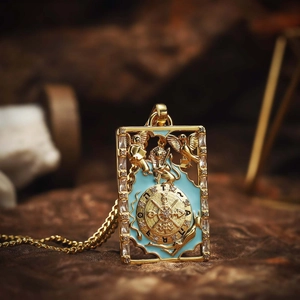 Vintage gold tarot card pendant necklace with blue enamel and sparkling zircon accents