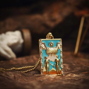 Vintage gold tarot card necklace featuring The Lovers pendant with blue enamel and zircons