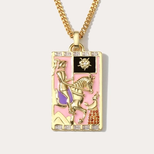 Detailed close-up of retro Death tarot pendant with pink enamel and gold chain