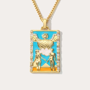 Detail of Lovers tarot card pendant with gold finish, blue enamel, and sparkling zircons