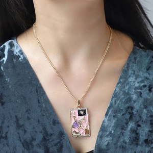 Detail showing tarot pendant with sparkling zircons and pink enamel horseman carving