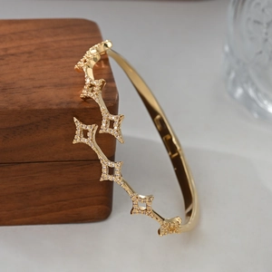 Macro shot of gold star-shaped bracelet with micro-pave cubic zirconia on wooden box