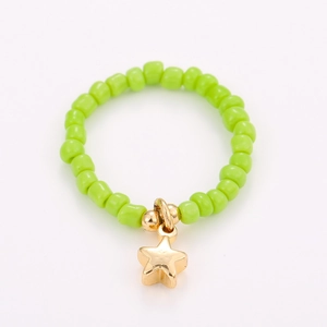 Close-up of green beads ring with gold star pendant and handmade elastic band