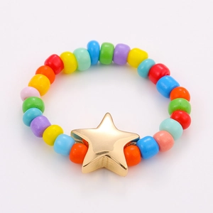 Detail of colorful beads and gold star charm on an elastic stacking ring set