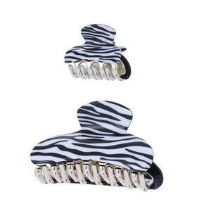 Detail view of zebra pattern hair claws in large and small sizes with silver metal comb